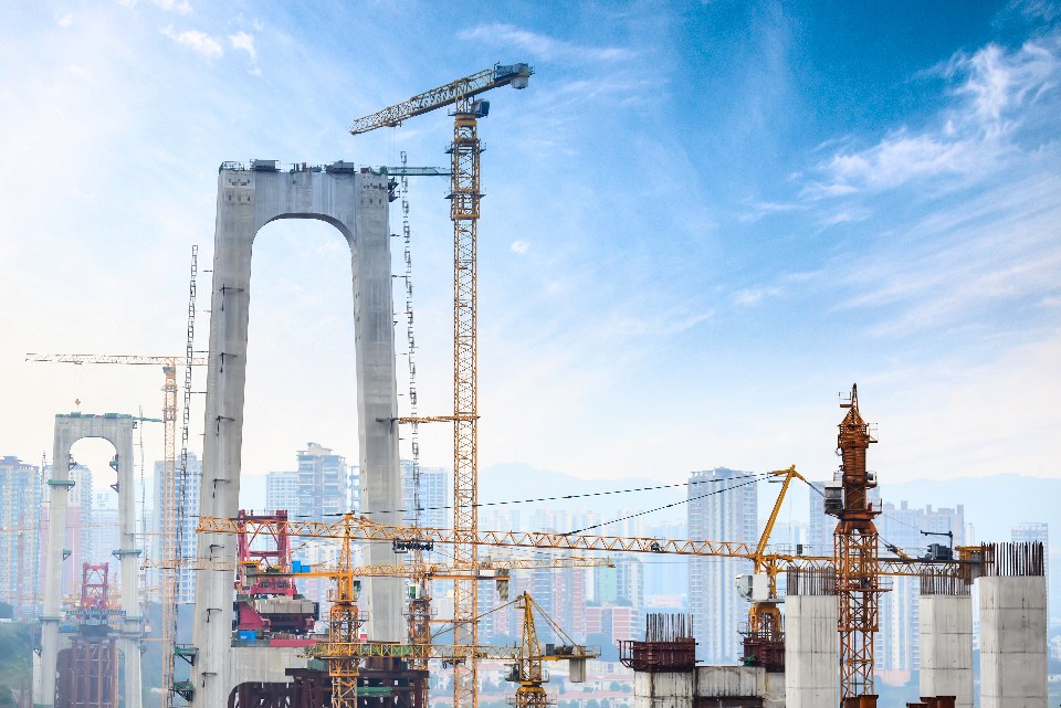 Cranes and structural columns at a construction site